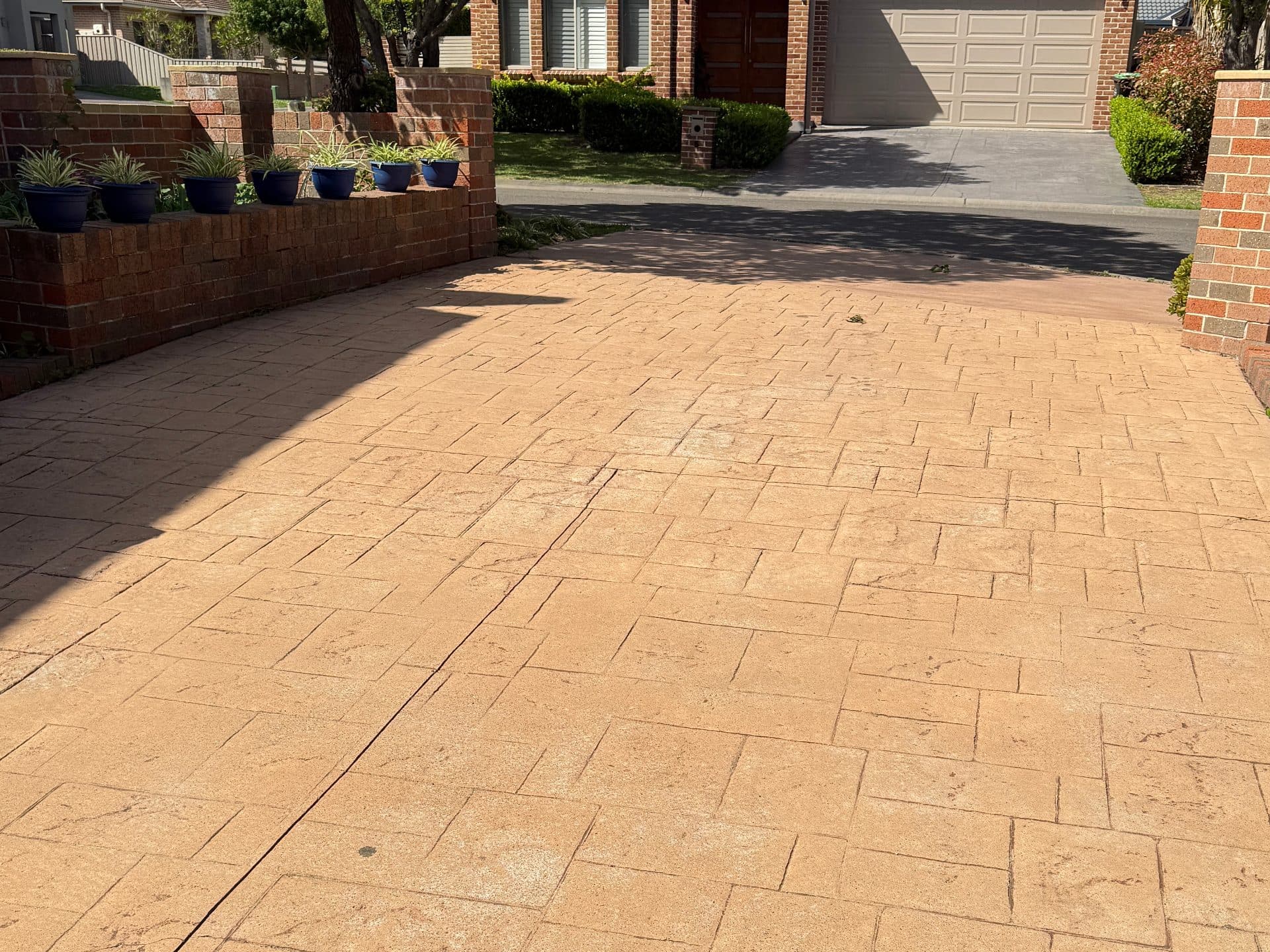 Sydney concrete driveway split before and after high-pressure cleaning by XSCAPE